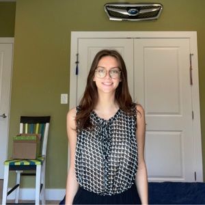 Black and white patterned sleeveless blouse.